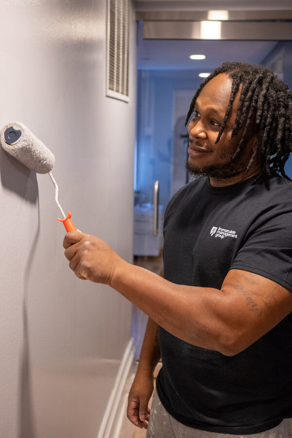 IMG painter rolling a fresh wall coat