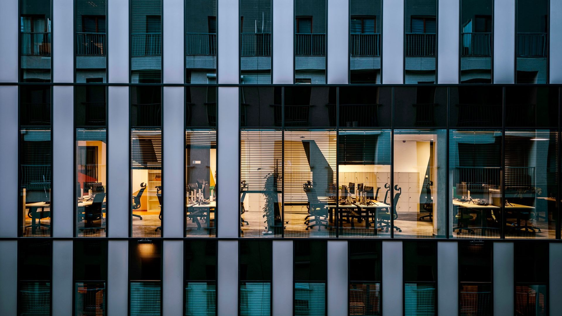 Glass office tower at dusk